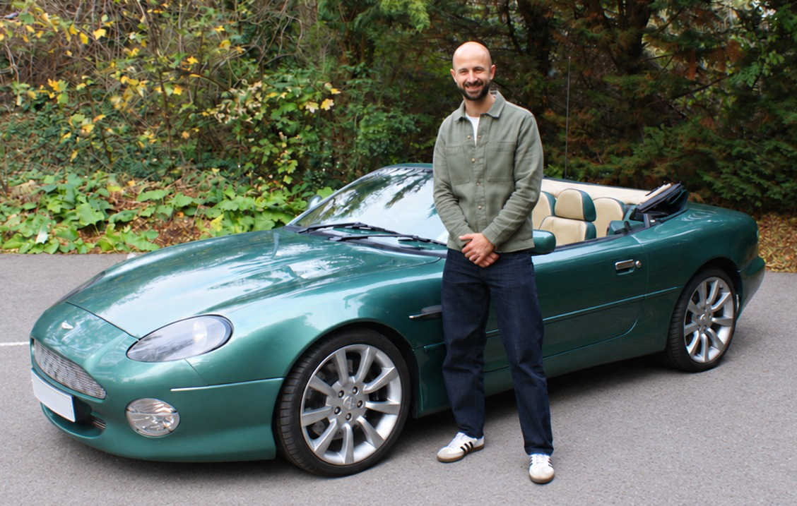 Andreas Tiganis beside a green Aston Martin convertible